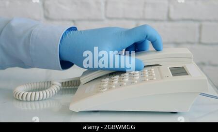 Image with Businessman Hands Wearing Protective Gloves Using Telephone Stock Photo