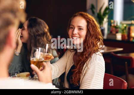 Woman toasting wine at dinner Stock Photo