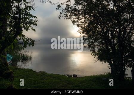 An early morning at Lac de Joux, Switzerland: Beautiful scenery with fog and the rising sun Stock Photo