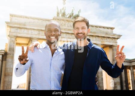 Gay Couple Making Victory Signs In Berlin Stock Photo