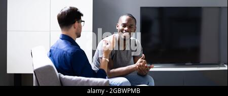 Couple Using Sign Language. Deaf African American On Sofa Stock Photo