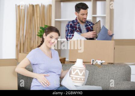 couple expecting a baby and moving to new house Stock Photo