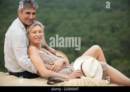 attractive married couple posing at the beach Stock Photo
