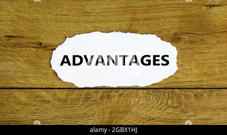 Advantages symbol. Concept word 'advantages' on white paper. Beautiful wooden background. Business and advantages concept, copy space. Stock Photo