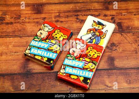 Vintage pack of Happy Families playing cards isolated on a wooden background Stock Photo