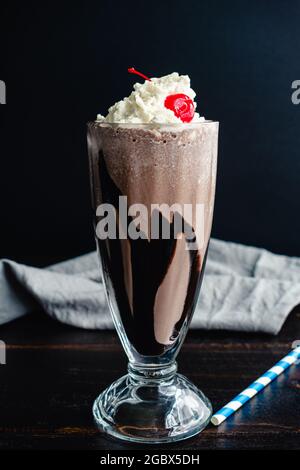 Bourbon Chocolate Milkshake with a Cherry On Top: A dark chocolate milkshake with bourbon whiskey with whipped cream topping Stock Photo