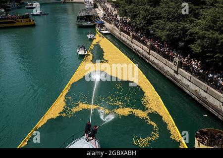 A staff member is fishing the rubber ducks floating in Futian River out of  the water after they reached the end point during a charity event at Shenzh  Stock Photo - Alamy