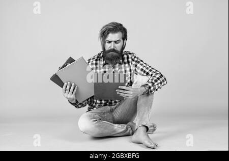 what should i do with this. casual styled man writing in document folder. paper work concept. typical office life. bearded man working with project Stock Photo