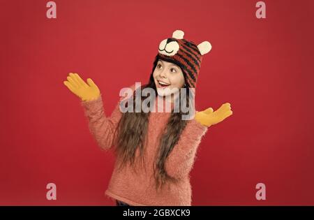 Capturing happy moment. holiday fun. cold season accessory. cheerful child in warm clothing. stylish teen girl with long hair in earflaps. winter kid Stock Photo