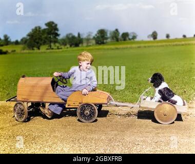 1930s 1940s BOY IN WOODEN TOY CAR PULLING DOG BEHIND IN WAGON - d421c HAR001 HARS 1 WAGON JUVENILE VEHICLE FRIEND BEST SPANIEL LIFESTYLE RURAL COPY SPACE FRIENDSHIP FULL-LENGTH PERSONS AUTOMOBILE MALES WHEELS ROD TRANSPORTATION RELEASES MAMMALS MAN'S BEST FRIEND ADVENTURE AUTOS CANINES LEADERSHIP PAL WAGON WHEELS AUTOMOTIVE MOTORING ZOOLOGY TOWING AUTOMOBILES FRIENDLY SPANIELS WAGON WHEEL WAGONS BEST FRIEND MAN'S MOTORIST ANIMALS DOG ANIMALS DOGS CANINE HOT ROD HOTROD HOTRODS JUVENILES MAMMAL PUP RODS SPRINGIER SPRINGIER SPANIEL SPRINGIER SPANIELS TOGETHERNESS YOUNGSTER BUDDY Stock Photo