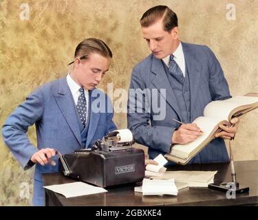 1920s BOOKKEEPER AND YOUNG ASSISTANT IN OFFICE USING LEDGER BOOK AND MANUAL ADDING MACHINE - o518c HAR001 HARS STRESS NOSTALGIC BUSINESSMEN TRAINING COLOR EXECUTIVE OLD TIME ARCHIVE NOSTALGIA MATH OLD FASHION CALCULATOR JUVENILE SECURITY YOUNG ADULT BALANCE NET SAFETY TEAMWORK INFORMATION ASSISTANT PIECE SATISFACTION CLERK HALF-LENGTH ADOLESCENT PERSONS MALES WRITE AMERICANA VEST MATHEMATICS CRANK DOT SUCCESS ACCOUNTANT OPERATING INKWELL DISCOVERY POLKA ACCOUNT ARCHIVAL TRAINEE ADDING LEADERSHIP ADDING MACHINE BOOKKEEPER DIRECTION AUTHORITY OCCUPATIONS TEACH ADD 3 PIECE SUIT BUSINESS MAN TALLY Stock Photo