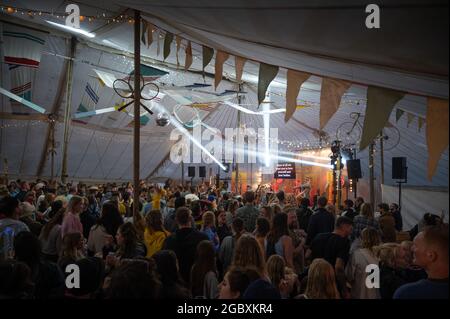 Wilderness Festival, Oxfordshire, UK. 5th Aug, 2021. Revellers enjoy Wilderness Festival despite the rain as the event starts its 10th year. It was postponed in 2020 due to Covid, but has been able to go ahead in 2021 with strict testing in place. Credit: Andrew Walmsley/Alamy Live News Stock Photo