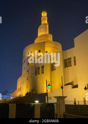 Illuminated Al Fanar – Tower at Qatar Islamic Cultural Center at night, Doha, Qatar, Middle east against clear dark sky Stock Photo