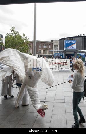 London, UK. 5th Aug, 2021. Stop HS2 campaigners use a HS2 white elephant holding a £170bn sign to carry out outreach activities directly in front of a HS2 Routewide Roadshow event at Kings Cross Square. There have been increasing doubts regarding the viability of the northern section of the HS2 high-speed rail link since a recent report published by the Infrastructure and Projects Authority gave Phase 2b the lowest 'red' rating, indicating that successful delivery of the scheme “appears to be unachievable”. Credit: Mark Kerrison/Alamy Live News Stock Photo