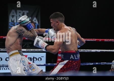 BRESCIA, ITALY - MAY 15: Mario Alfano (red) and Nicola Henchiri (white) exchange punches during their fight for the EU super featherweight title at the Mario Rigamonti Sport Center on May 15, 2021 in Brescia, Italy.  Credit: Stefano Nicoli/Speed Media/Alamy Live News Stock Photo