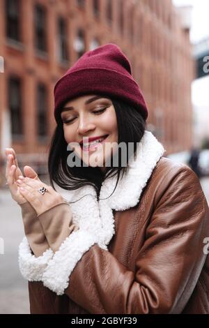 Young woman happy smile with closed eyes over New York street. Portrait of casual female outdoors Stock Photo