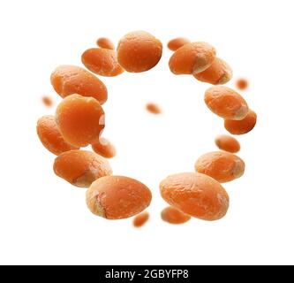 Red lentils levitate on a white background Stock Photo