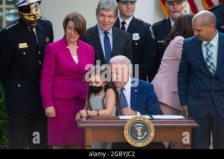 Abigail Evans, daughter of slain Capitol Police Officer William “Billy” Evans, joins United States President Joe Biden, as he prepares to sign H.R. 3325, “An Act to award four Congressional gold medals to the United States Capitol Police and those who protected the U.S. Capitol on January 6, 2021,” into law in the Rose Garden of the White House in Washington, DC, Thursday, August 5, 2021. Looking on are US Senator Amy Klobuchar (Democrat of Minnesota) and Roy Blunt (Republican of Missouri). Credit: Rod Lamkey/CNP/MediaPunch Stock Photo