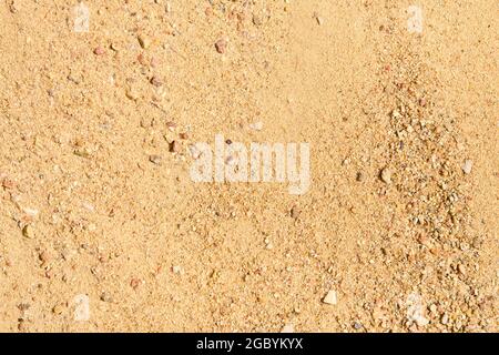 River rocky sand in sunny day macro closeup sandy background for concrete mix in construction industry. Stock Photo