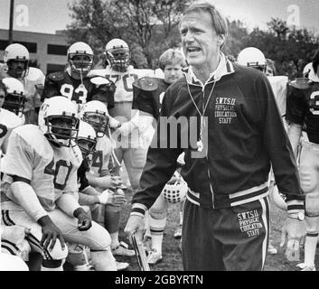 San Marcos Texas USA, circa 1982: Football coach Jim Wacker of Southwest Texas State University shouts instructions to his players during practice. ©Bob Daemmrich Stock Photo