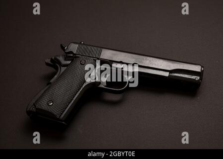 9mm Pistol gun on black color background. Black metal weapon, automatic handgun for military and security. Side view Stock Photo