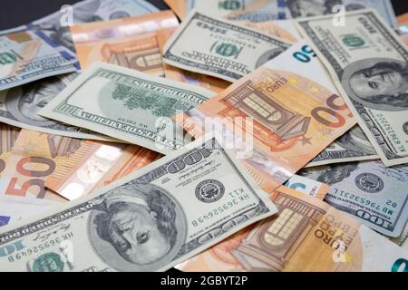 Euro and US dollars notes pile, closeup view. Banknotes background. Money cash, credit exchange and international finance concept Stock Photo