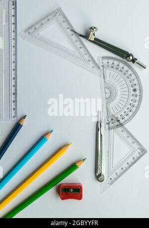 Geometric Measuring tools, Drawing items and mathematical instruments placed on white paper sheet. Back to school and Engineering education learning b Stock Photo
