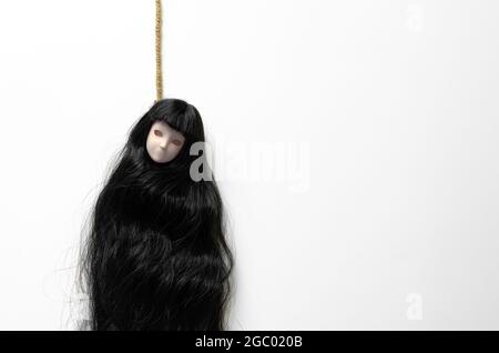 creepy girl with black hair and doll