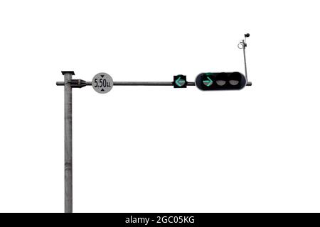 Traffic light pole showing the green lights to turn left and turn right isolated on white background. Stock Photo