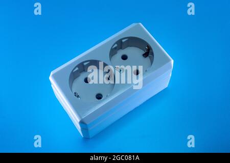 Electric double socket on a blue background Stock Photo