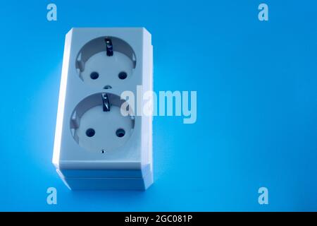 Electric double socket on a blue background Stock Photo
