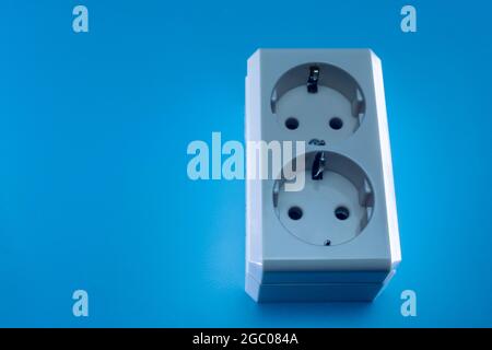 Electric double socket on a blue background Stock Photo