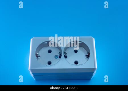 Electric double socket on a blue background Stock Photo