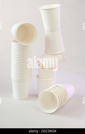 plastic free concept. tableware without plastic.Zero waste, Bamboo organic cups. White paper cups on beige background.Paper bamboo cups set.Recycling Stock Photo