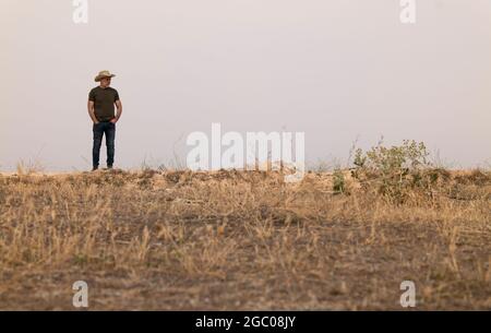 A man wearing a cowboy hat in the countryside Stock Photo