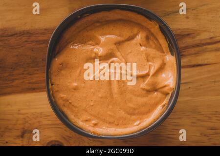 Spicy Mayonnaise. Tray of spicy mayonnaise for stuffing hamburgers. Spicy sauce for your burgers. Burger sauce. Sauce and vegetables for burgers. Stock Photo