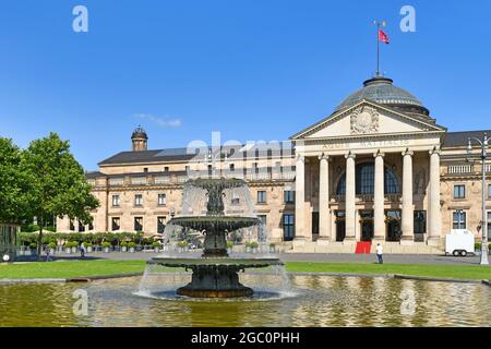 Wiesbaden, Germany - July 2021: Fountain in public park called 'Bowling Green' in front of convention center called Stock Photo