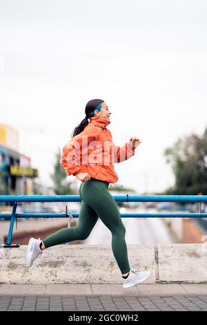 Pretty blonde girl with ponytail is training in sports clothes on