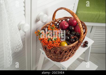 Thanksgiving set of fruits and vegetables in basket. White interior Stock Photo