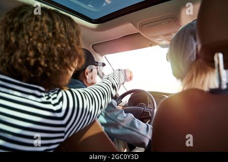 group of asian friends enjoying a sightseeing trip by car Stock Photo