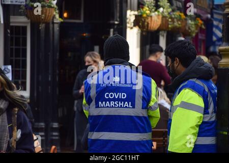 London, United Kingdom. 14th April 2021. Covid marshals on patrol in Old Compton Street, Soho. Stock Photo