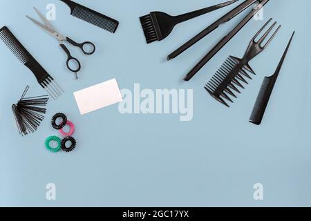 Hairdresser tools on blue background with copy space, top view, flat lay. Stock Photo