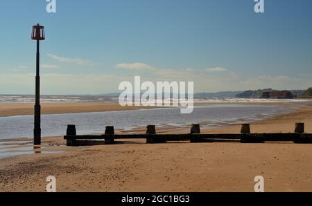 A groyne and marker beacon on Dawlish Warren beach at low tide. Stock Photo