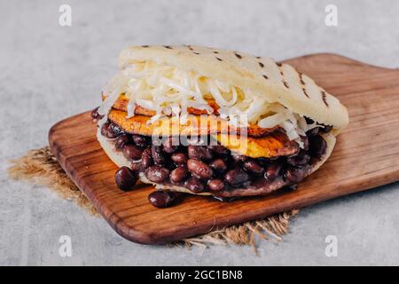 Typical Venezuelan arepa, made with fried plantain, black beans and cheese Stock Photo