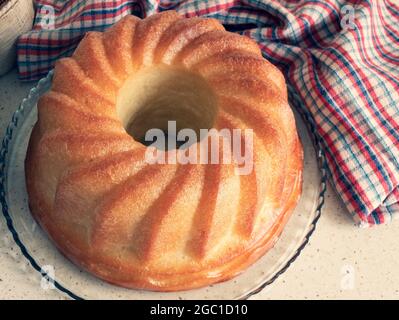 Rum-soaked circular cake Savarin. Freshly-baked rum baba. Yeasted cake baked in a ring mold and soaked in a sweet syrup Stock Photo
