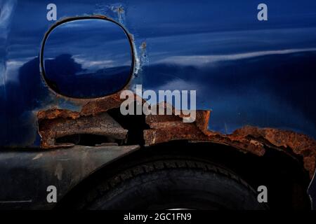 Corrosion of metal on a car body, close up. Rust on the car Stock Photo