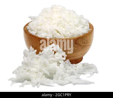 Fresh coconut flakes in wooden bowl on white background Stock Photo