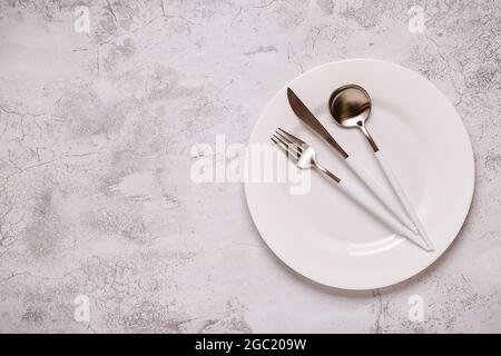 Clean empty white plate with cutlery. Copy space, mock up, top view. Concept for menu with utensil. Stock Photo