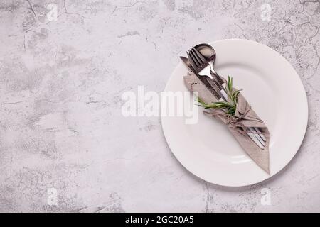 Clean empty white plate with cutlery. Copy space, mock up, top view. Concept for menu with utensil. Stock Photo