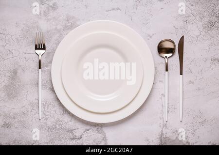 Clean empty white plate with cutlery. Copy space, mock up, top view. Concept for menu with utensil. Stock Photo